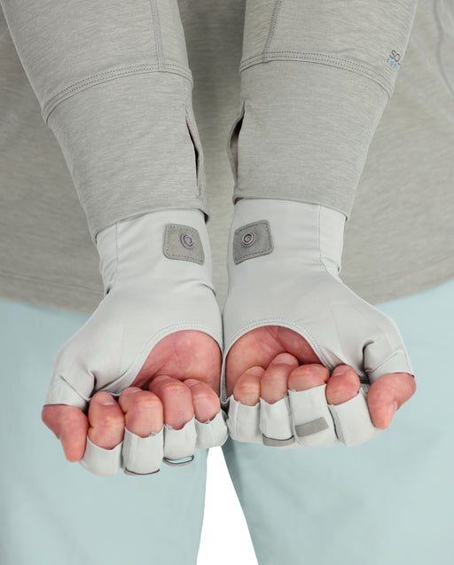 a person wearing sungloves to show open palm and half fingers