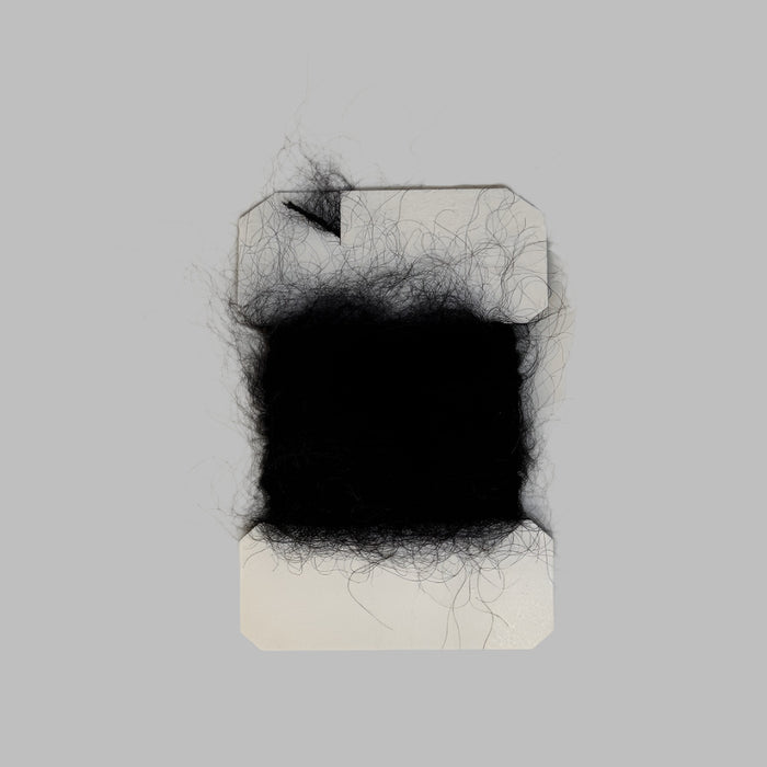Black colored leach yarn on a card