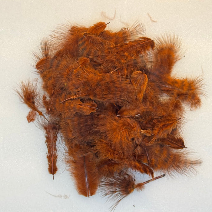 A pile of brown grizzly marabou feathers