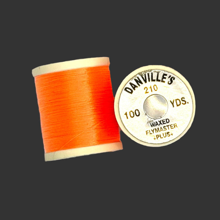 Fluorescent Orange spool of thread from top and side view