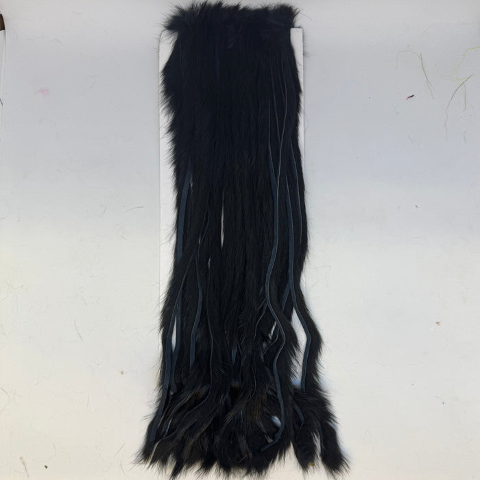 Long strips of black rabbit fur on a card