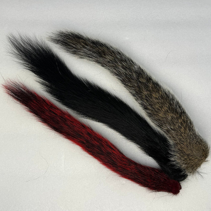 Red, Black and Natural Gray Squirrel Tails on white background