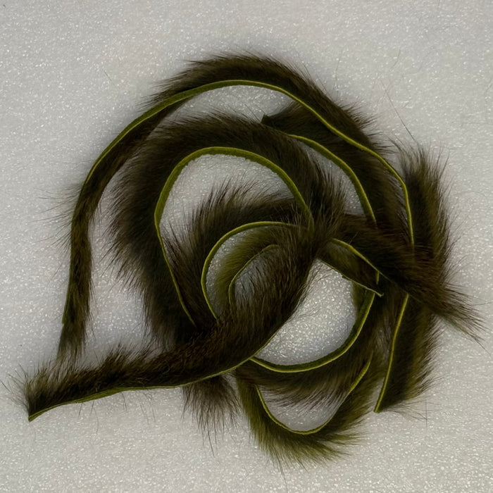 Close up of small pile of olive colored squirrel fur strips