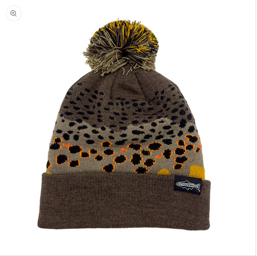 a knit cap with pom pom on top and colored design that looks like brown trout skin
