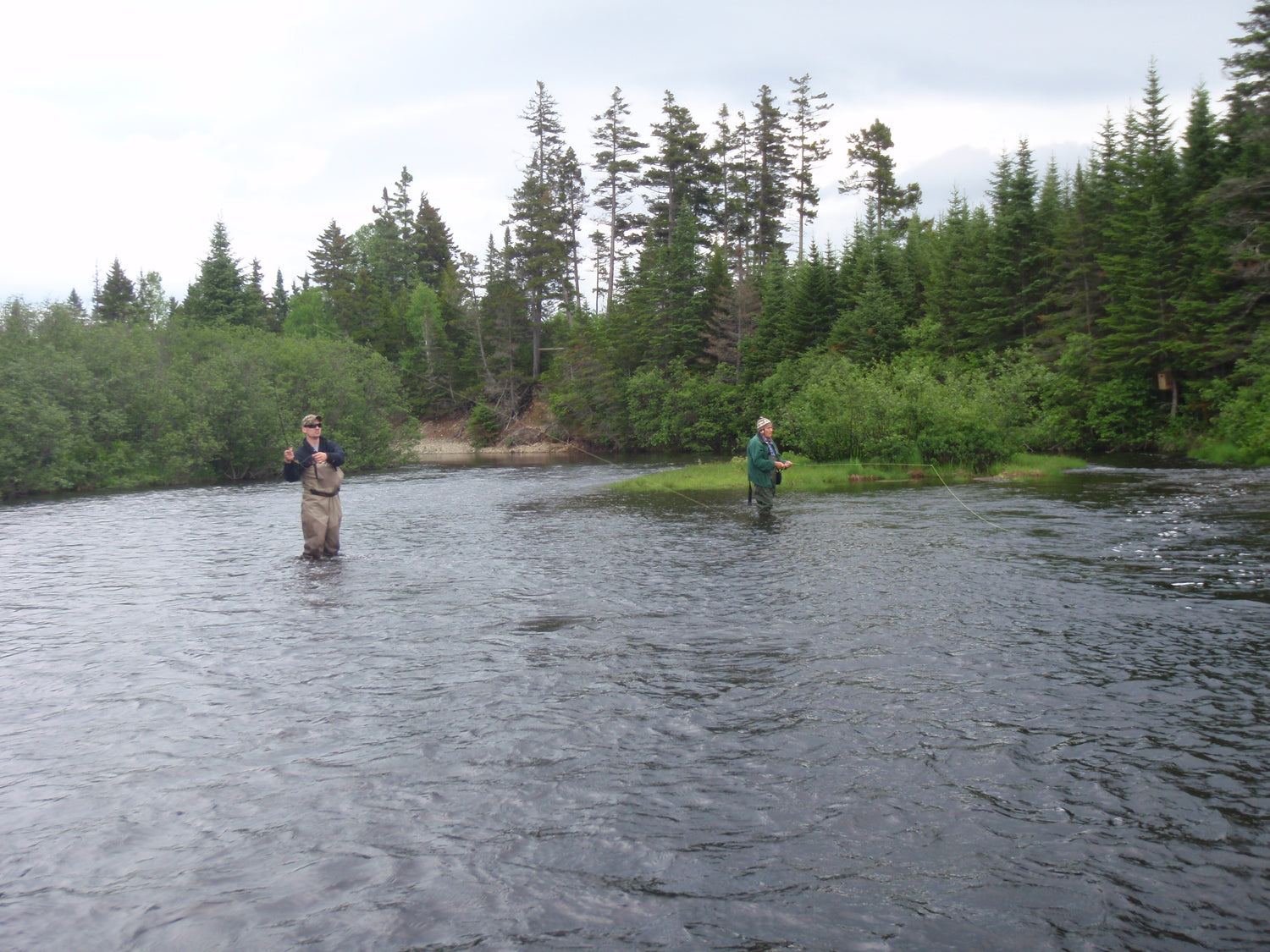 two people fishing a bend in a river with a registered maine guide in Rangeley