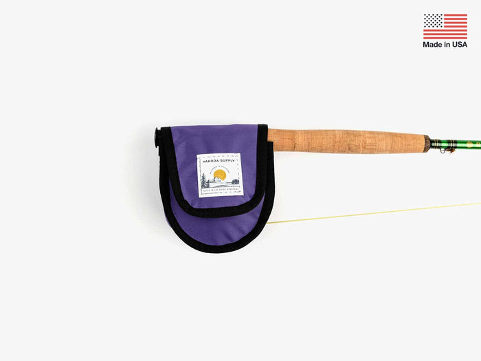 Purple reel cover on tip of rod on white background