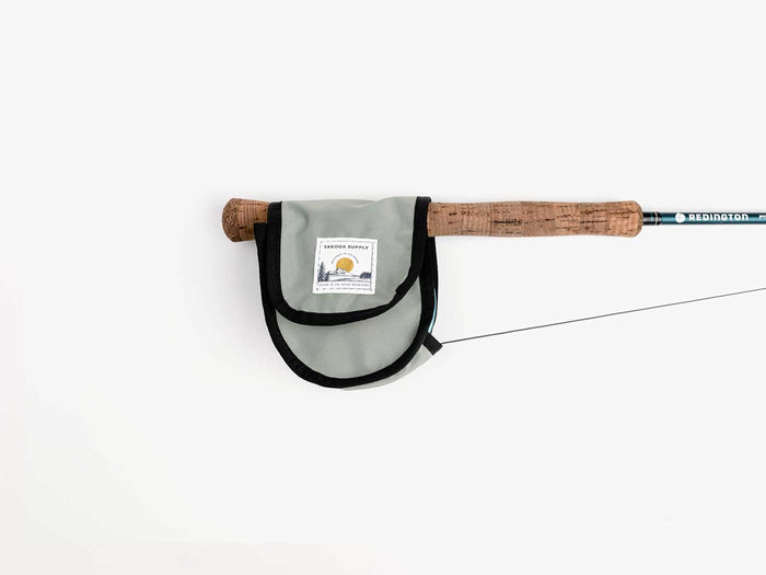 Silver reel cover on rod handle with white background