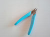 blue handled pliers with line cutter excellent for bending barbs on fly fishing flies