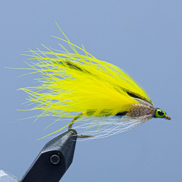 the streamer fly called the yellow ghost has black and tinsel body, yellow marabou wing topped with peacock herl and mallard cheek
