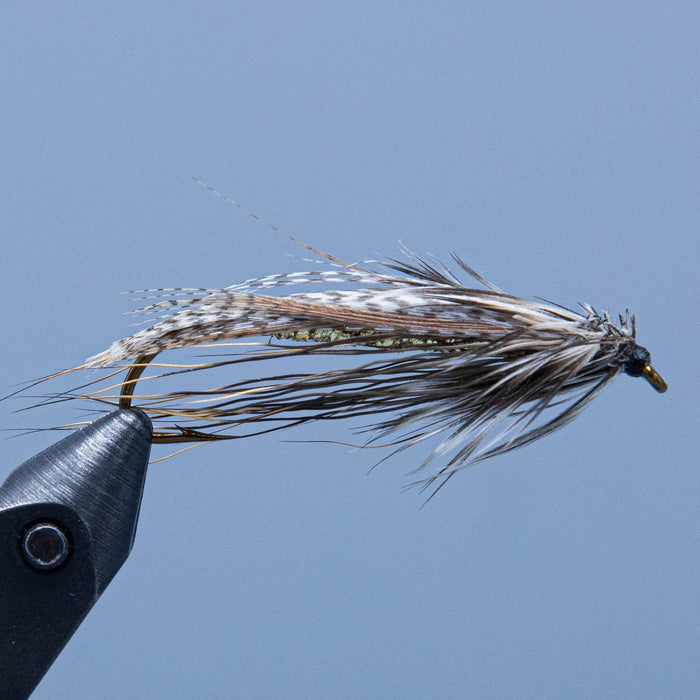 A flat wing streamer fly in natural colors called the brown owl from a maine fly shop