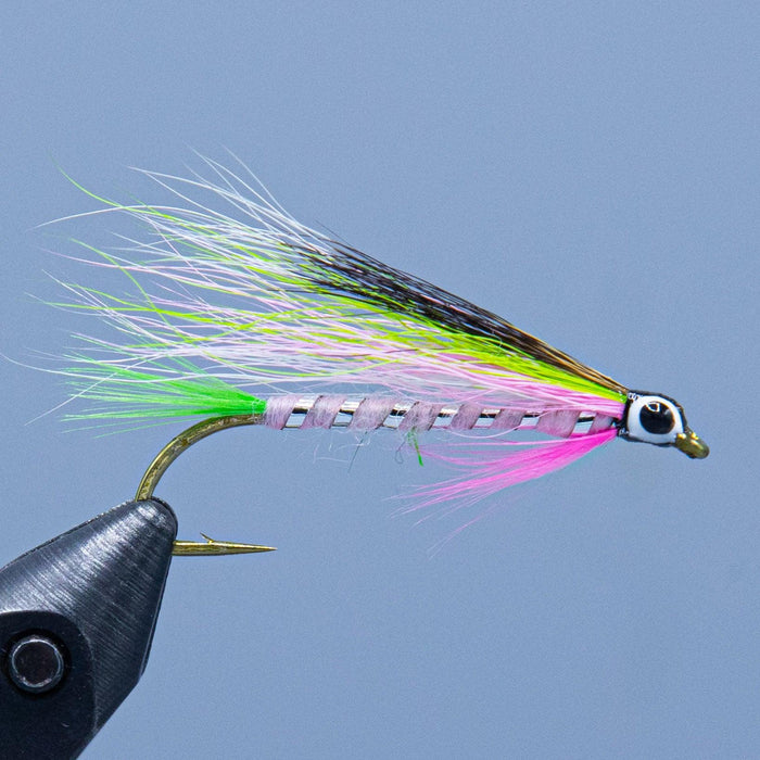 a pink and silver body, green tail, pink throat and multicolored bucktail wing make the little rainbow trout streamer fly at a maine fly shop