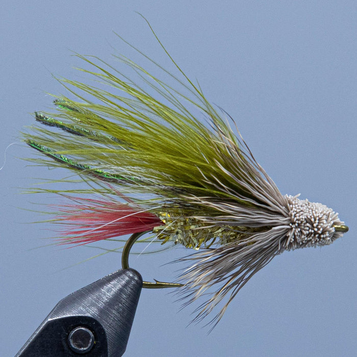 a marabou muddler with olive wing, red tail, and gold body at a Rangeley, maine fly shop