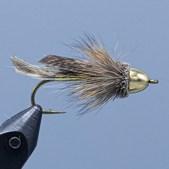 conehead muddler minnow with gold body and natural feathers and fur at a Rangeley maine fly shop