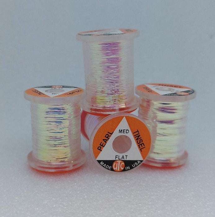 four spools of four sizes of pearl tinsel used for tying flies