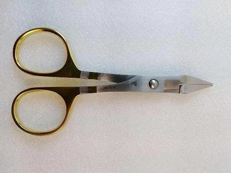 a fly fishing scissor clamp used for cutting stout materials and crushing barbs
