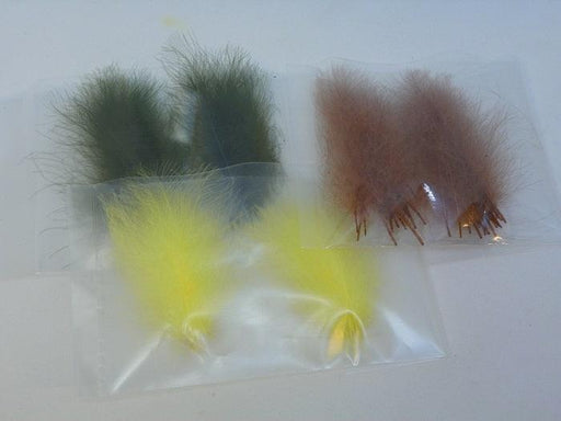 three packages of super select C.D.C feathers - olive, yellow, and cinnamon