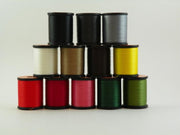 Assorted thread spools set in red, black, tan, yellow, and other colors