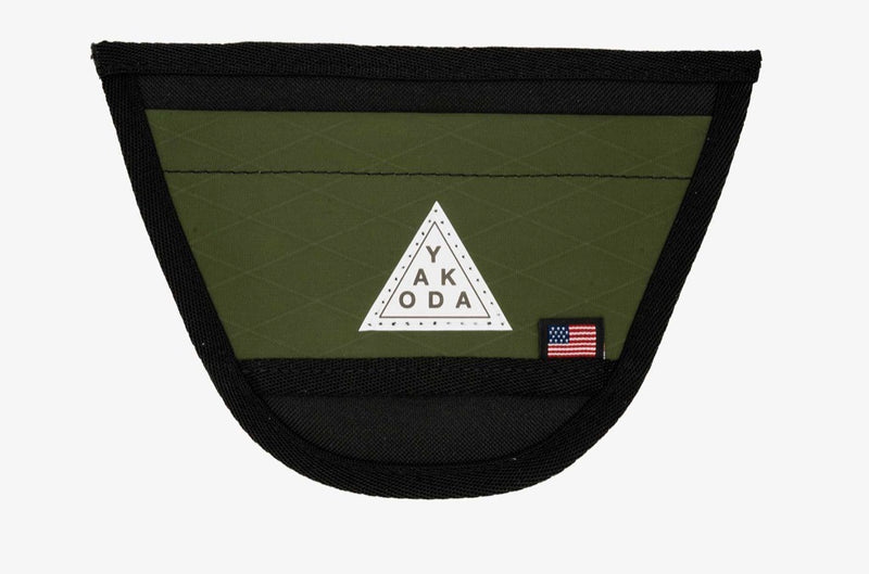 Yakoda net holder pouch with black trim and moss-green mesh, triangular logo patch and flag tag