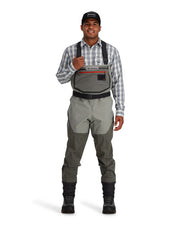 Simms Freestone stockingfoot waders on model, gray bib with red trim