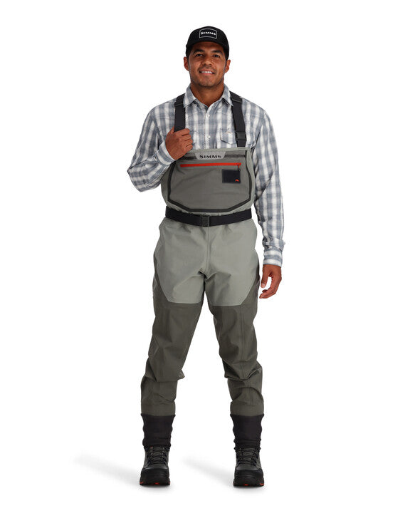 Simms Freestone stockingfoot waders on model, gray bib with red trim