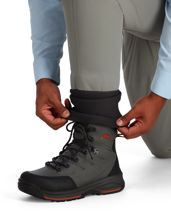 Smoke gray wading pants with black neoprene boot cuffs over water shoes