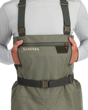 Stockingfoot wader chest pocket detail with Simms logo and adjustable suspenders