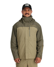 Simms Challenger jacket in olive, zip front, hood, worn with cap