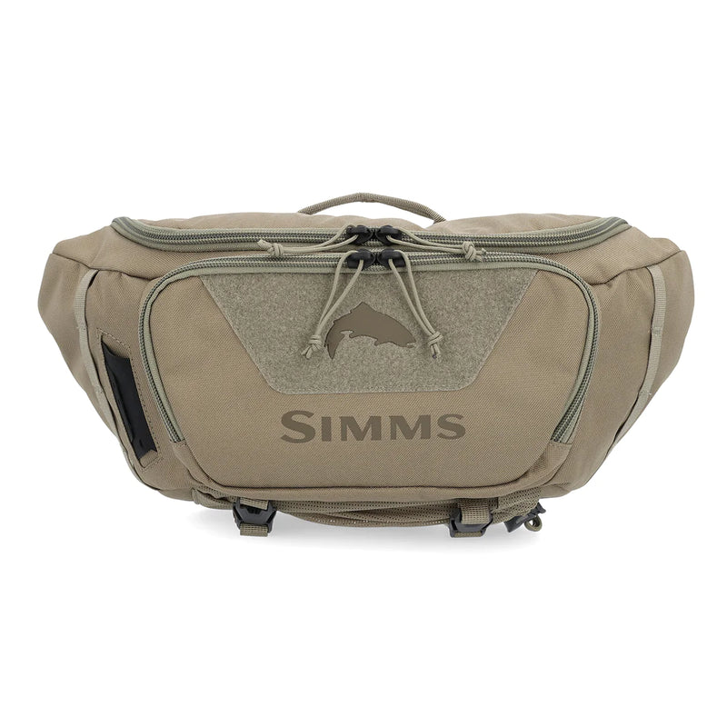 Simms tan Tributary hip pack with front zipper pocket and logo