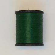 Dark green sewing thread spool with black ends