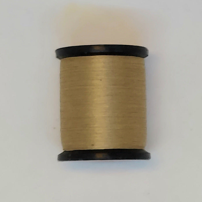 Tan sewing thread spool with black ends