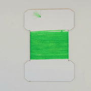Green yarn on cards, bright green fibers wound on a white card