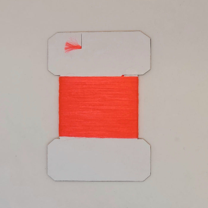 Red yarn on cards, bright red fibers wound on a white card