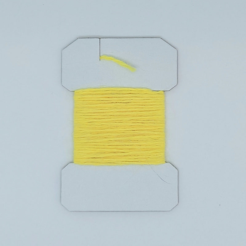 Woolly Bugger yarn on cardboard spool, bright yellow