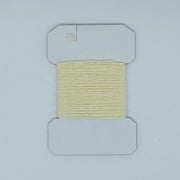 Woolly Bugger yarn on cardboard spool, pale cream