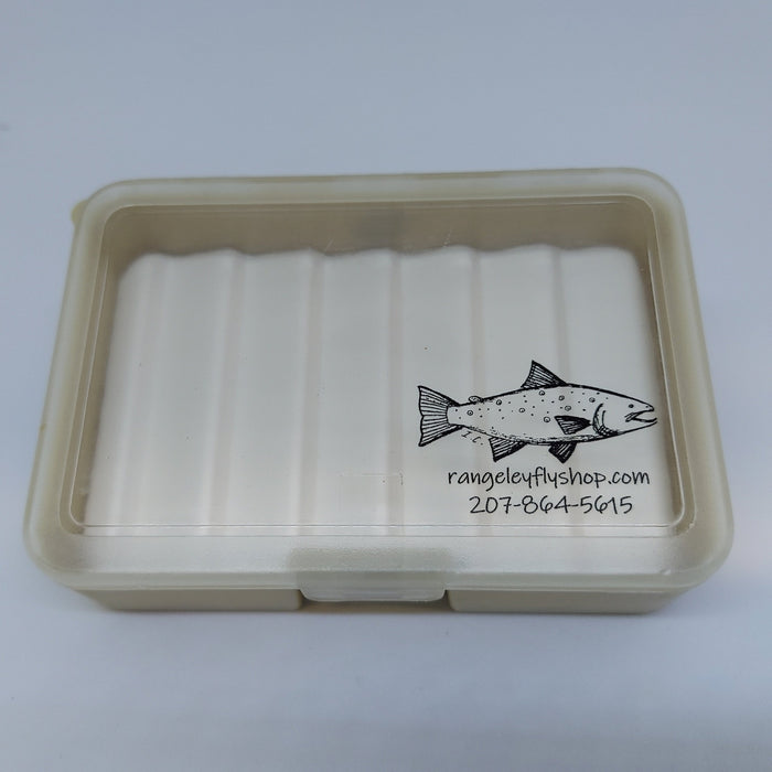 A small fly box with tan bottom with ripple foam and clear lid with rangeleyflyshop.com logo