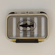 Double-sided water-resistant fly box, closed tan shell with Rangeley Region logo