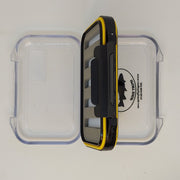 Double-sided water-resistant fly box, open with black and yellow hinge compartments
