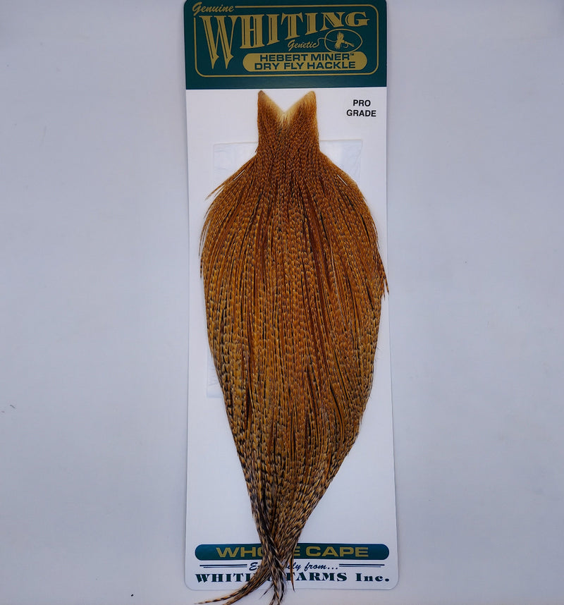 Barred ginger-brown hackle cape with pointed top and long feather fibers on card