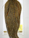 Gold and dark speckled hackle cape with long feather strands, pointed top.