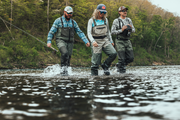 Stockingfoot waders on anglers, olive bib with chest straps and black boot uppers