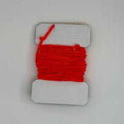 Chenille yarn bundle with red ribbed strand wrap