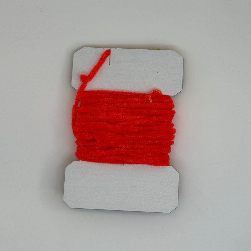 Chenille yarn bundle with red ribbed strand wrap