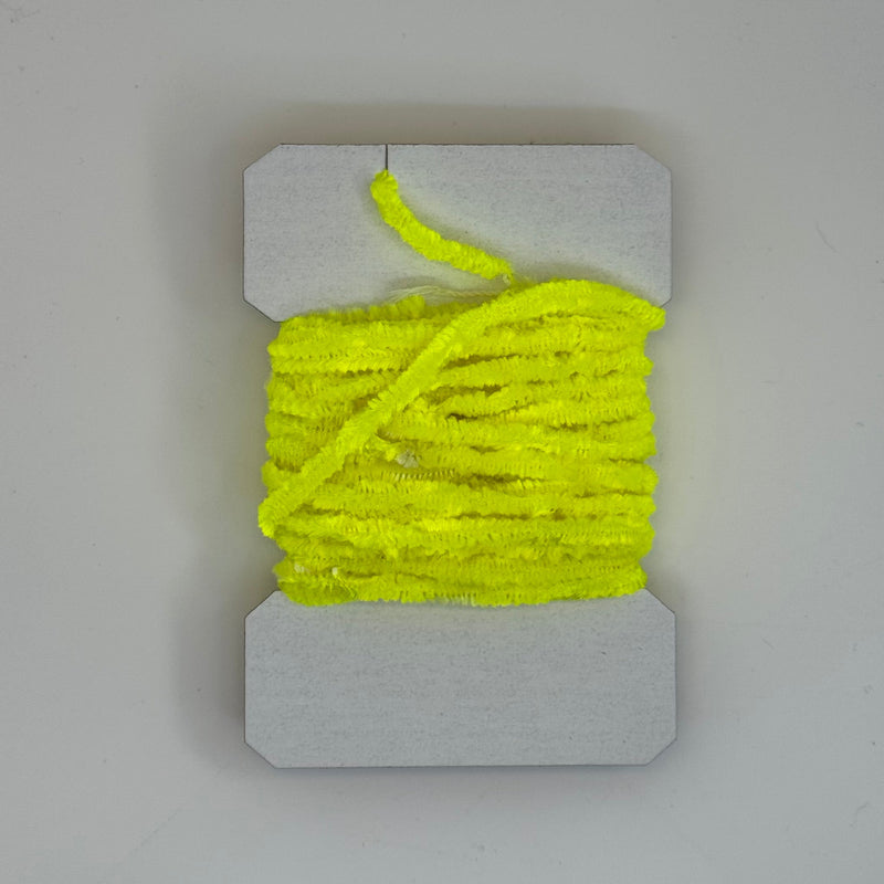 Chenille yarn bundle in neon yellow, tightly looped with yarn tail visible