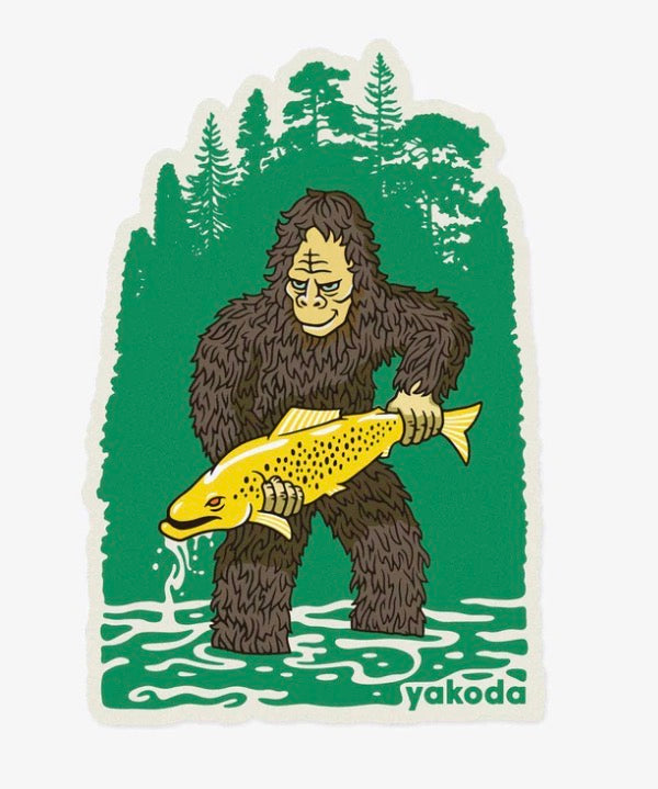 Yakoda Bigfoot sticker with green forest scene, bigfoot holding a fish, white border