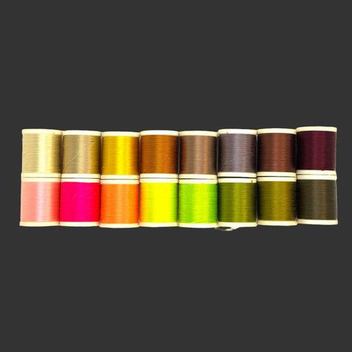 Sixteen spools in various colors lined up in two rows