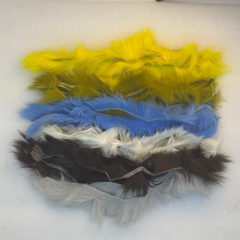 Crosscut rabbit fur strands in yellow, blue, white, and dark tones