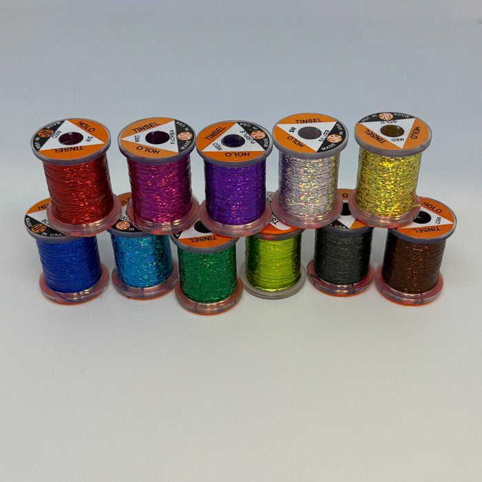 11 spools of tinsel in various colors stacked in two rows