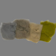 Rabbit dubbing material in mixed colors: gray, cream, and bright yellow.