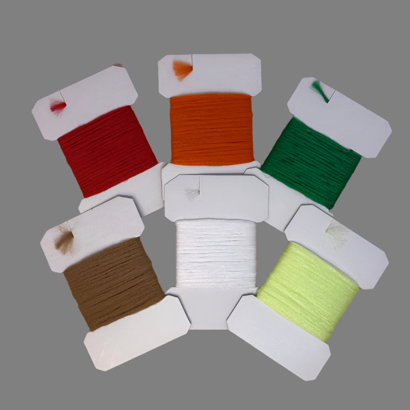 Assorted polypropylene floating yarn spools in red, orange, green, brown, white, yellow