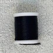 Four-strand floss spool in black with loose thread